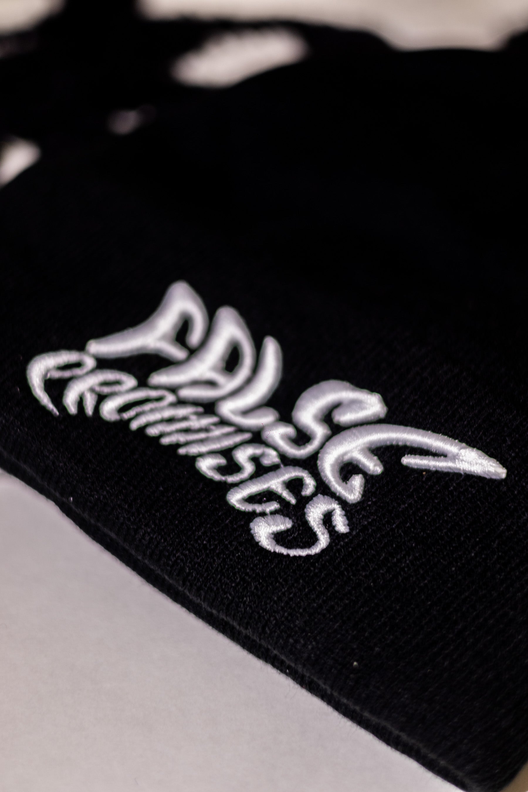 FALSE PROMISES WHITE ON BLACK KNITTED BEANIE